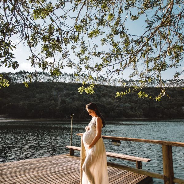 Person stretching gently outdoors with a serene smile.
