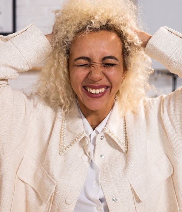 Woman feeling energetic and happy in a bright living room.